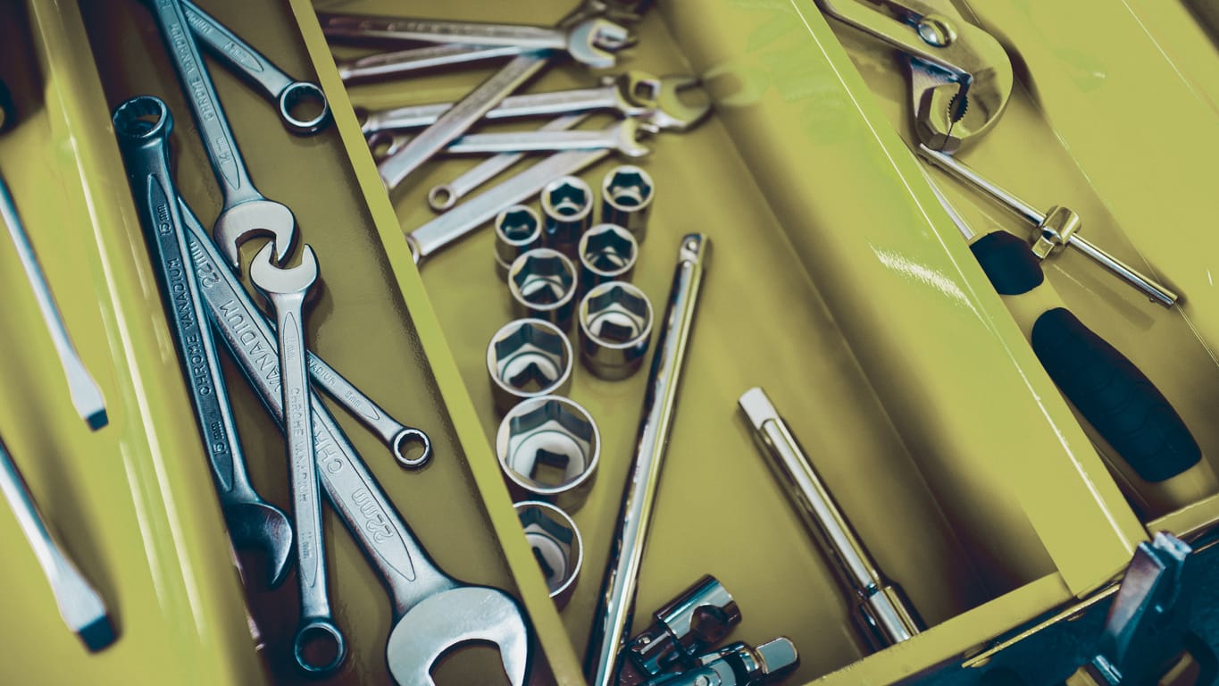 Mechanic workshop. Closeup of open professional toolbox with chrome wrench instruments.