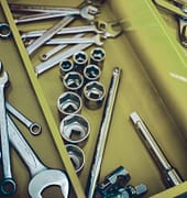 Mechanic workshop. Closeup of open professional toolbox with chrome wrench instruments.